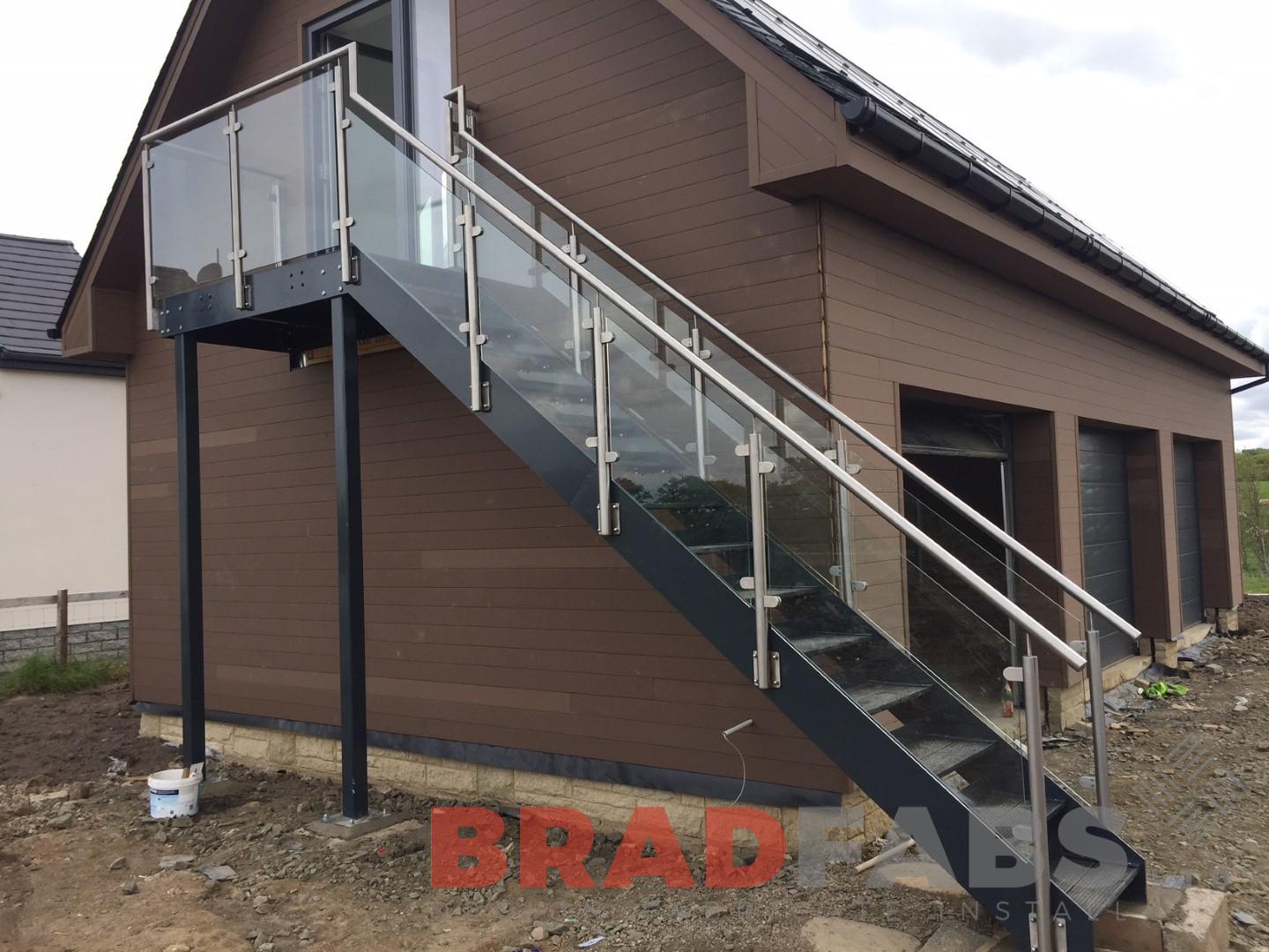 large straight external staircase in mild steel, galvanised and powder coated with durbar treads, glass infill panels and stainless steel balustrade by Bradfabs Ltd 