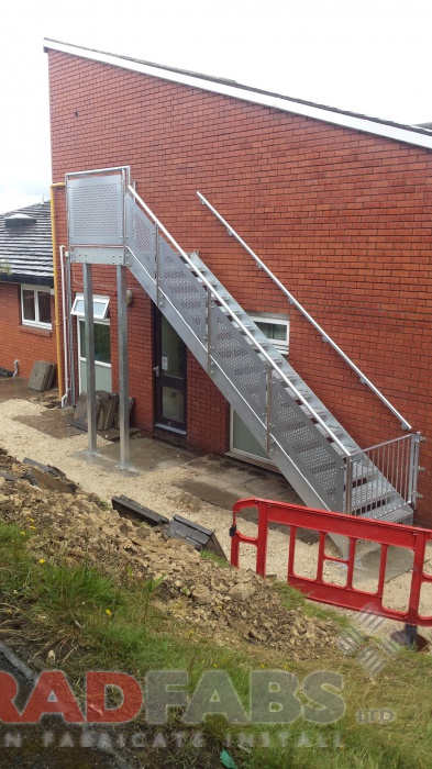 Single flight staircase with wall mounted handrail