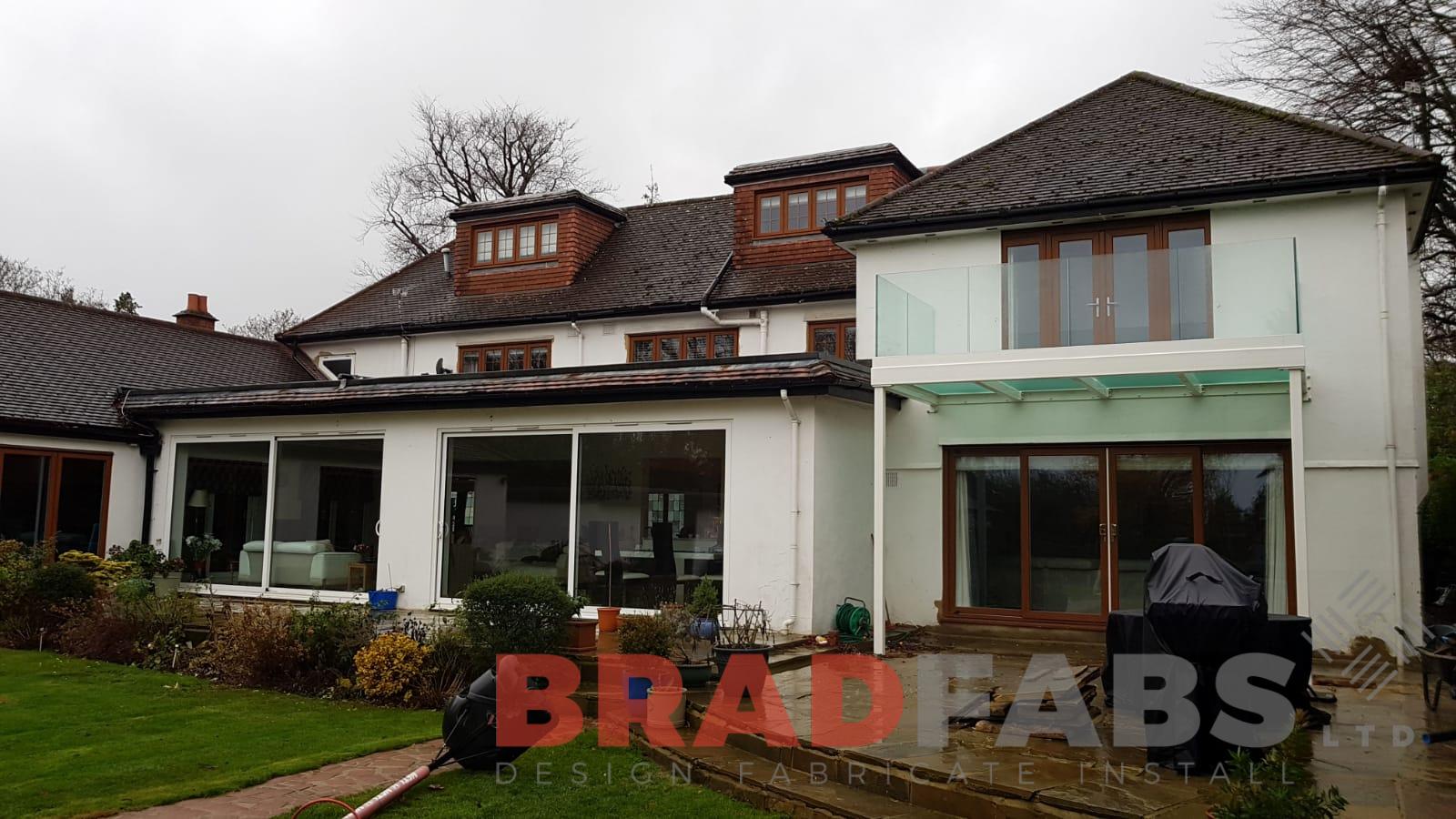 Beautiful glass floor balcony with infinity glass balustrade and galvanised finish by Bradfabs 