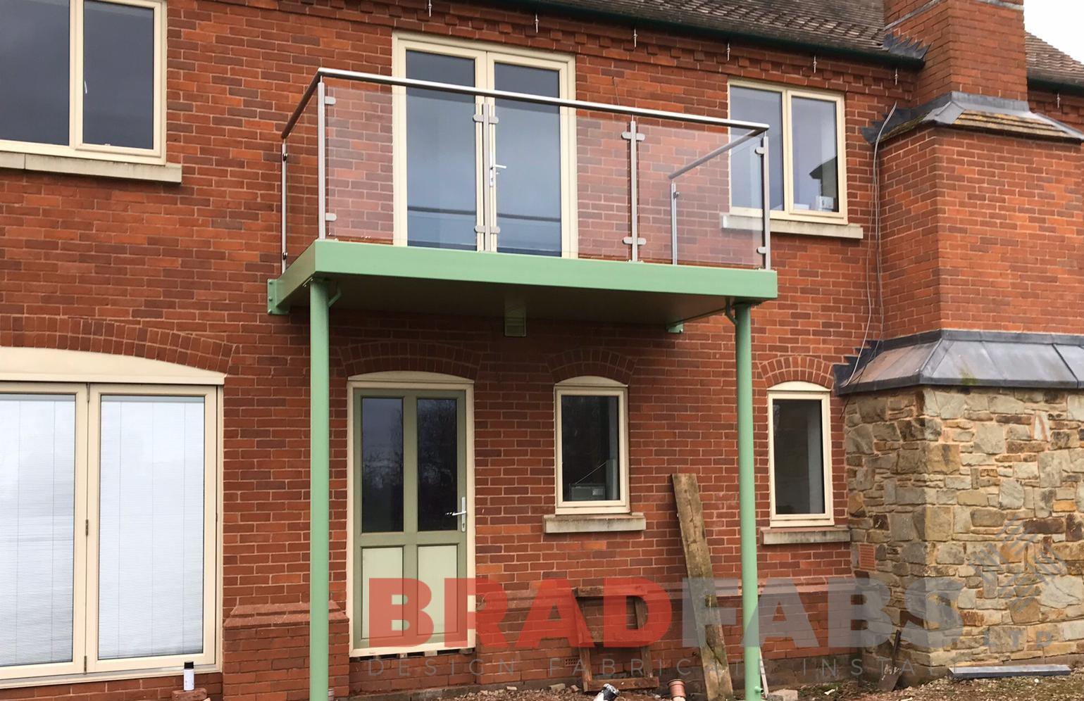 Balcony with supporting legs, mild steel, galvanised and powder coated with stainless powder coated panels underneath by Bradfabs 