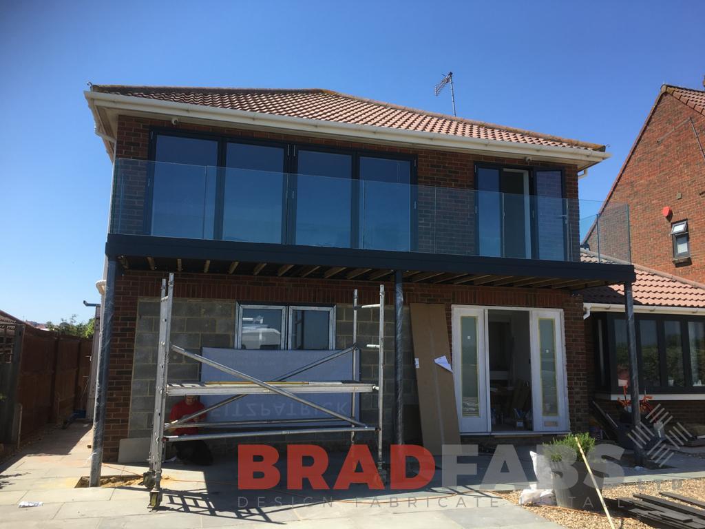 Bespoke balcony with channel system infinity glass balustrade by Bradfabs 