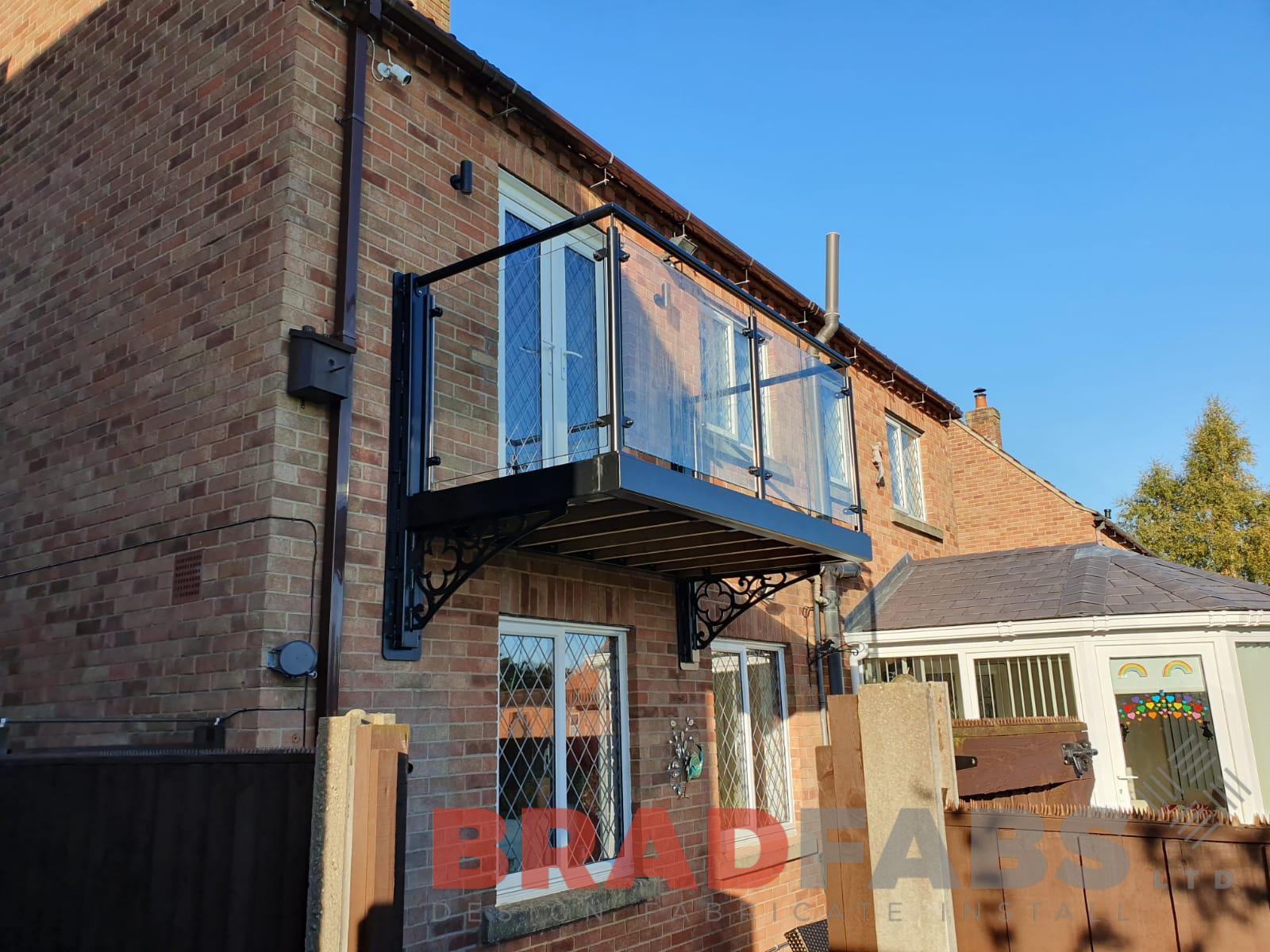 Cantilevered balcony with decorative steelwork to support brackets by Bradfabs Ltd 