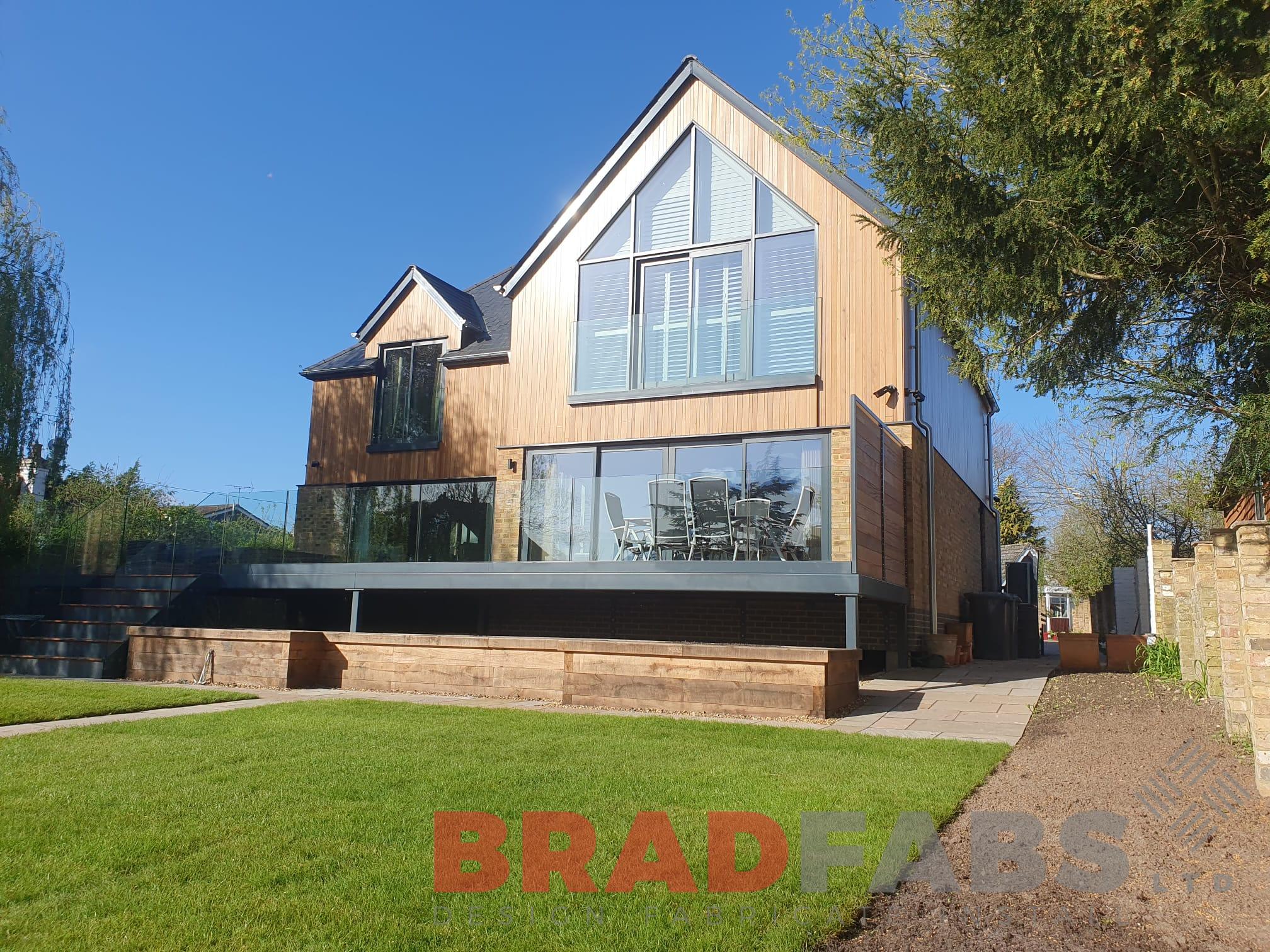 Balcony with staircase complete with frameless glass balustrade by bradfabs