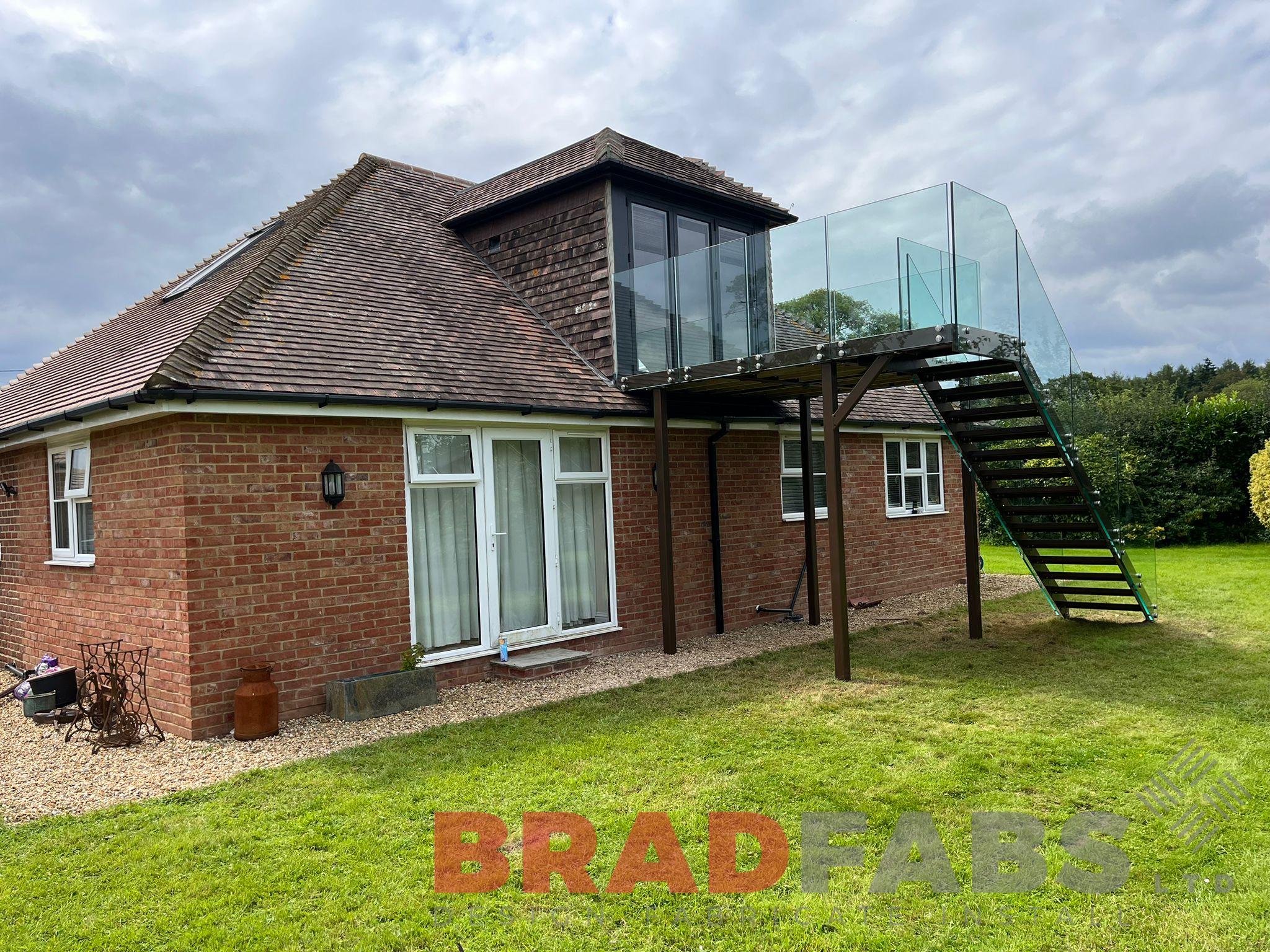 Balcony with straight staircase and infinity glass balustrade by bradfabs