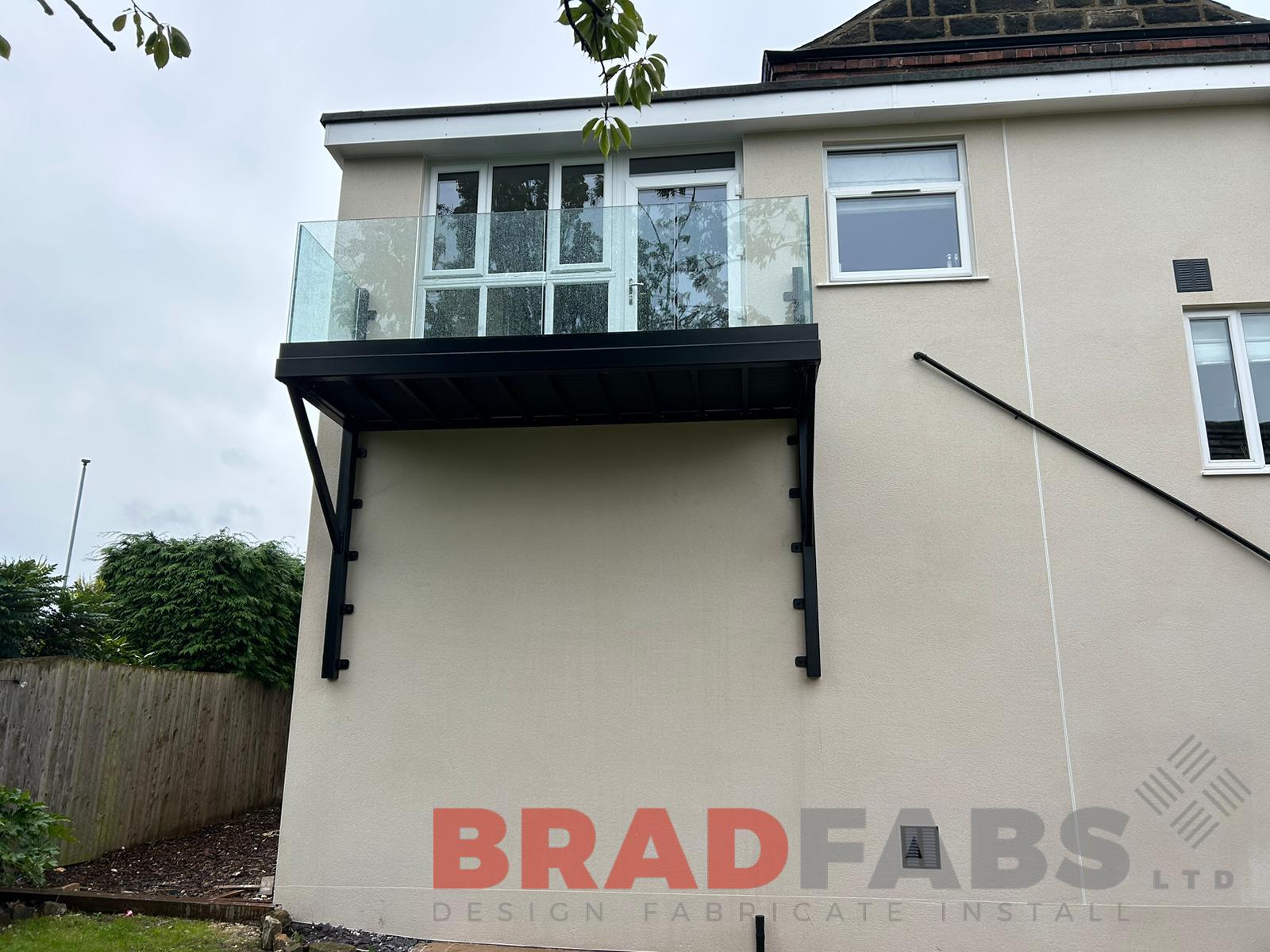 Balcony, cantilevered balcony with glass balustrade and composite decking by bradfabs 