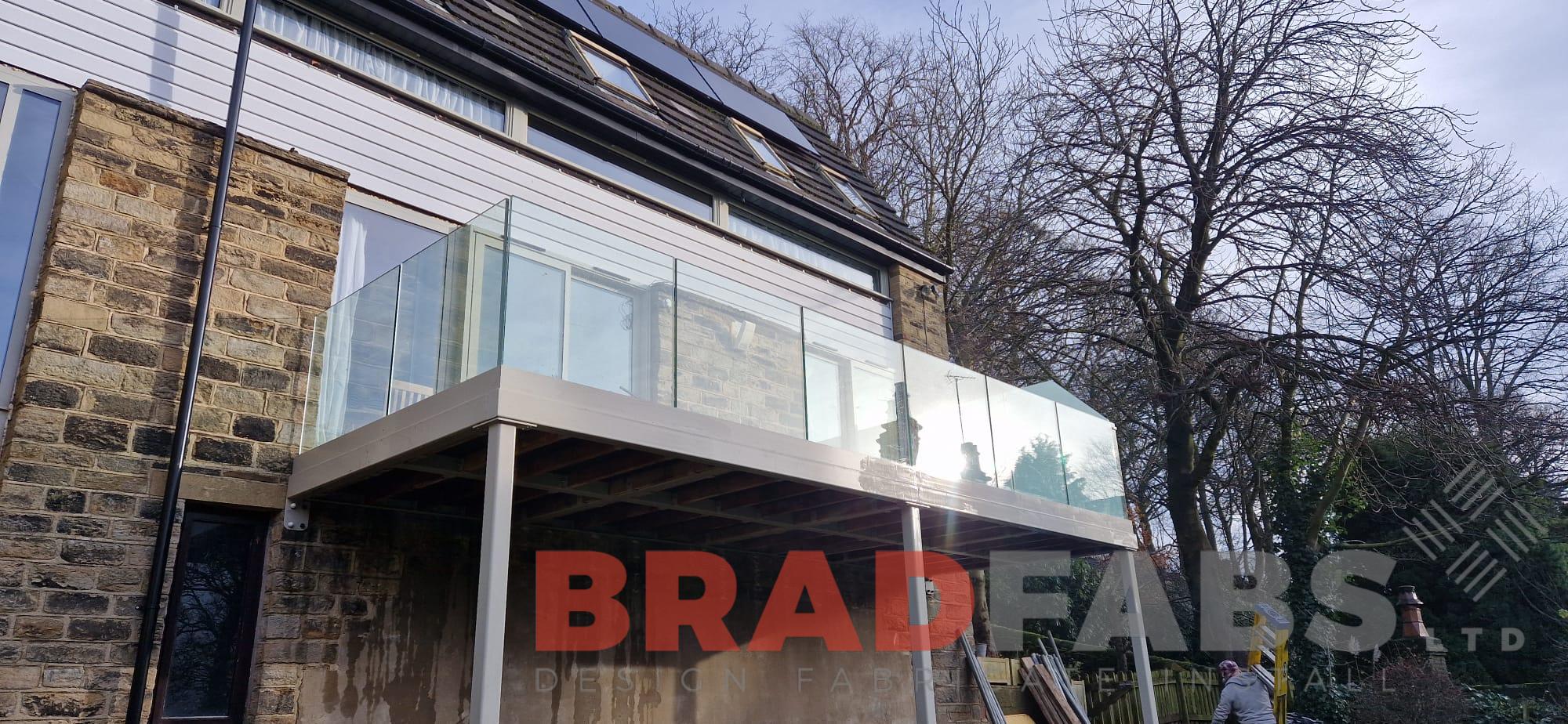 Bespoke balcony with glass balustrade and privacy screen by bradfabs