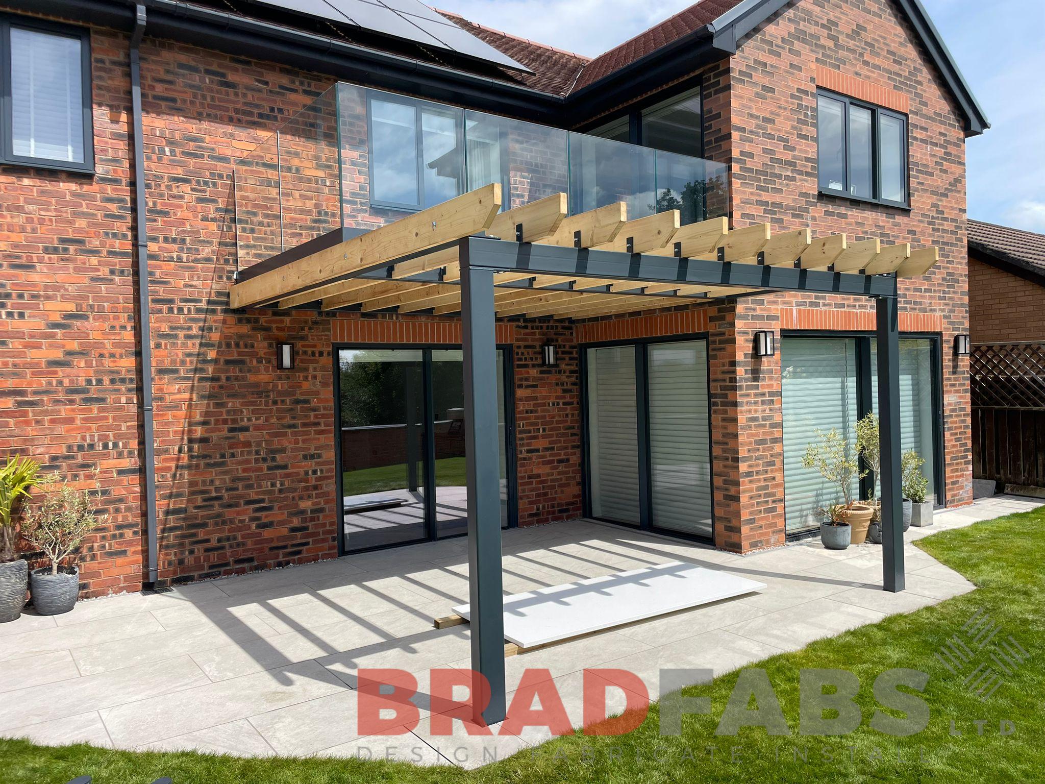 Balcony with pergola style section, steel balcony frame with glass balustrade, Bradfabs design 