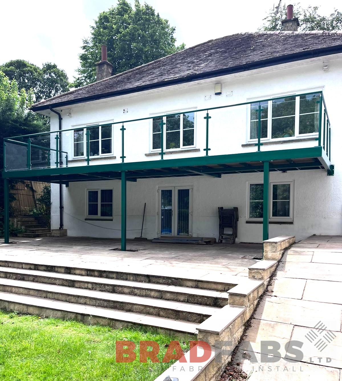 Large balcony powdercoated green, installed in Leeds, West Yorkshire.