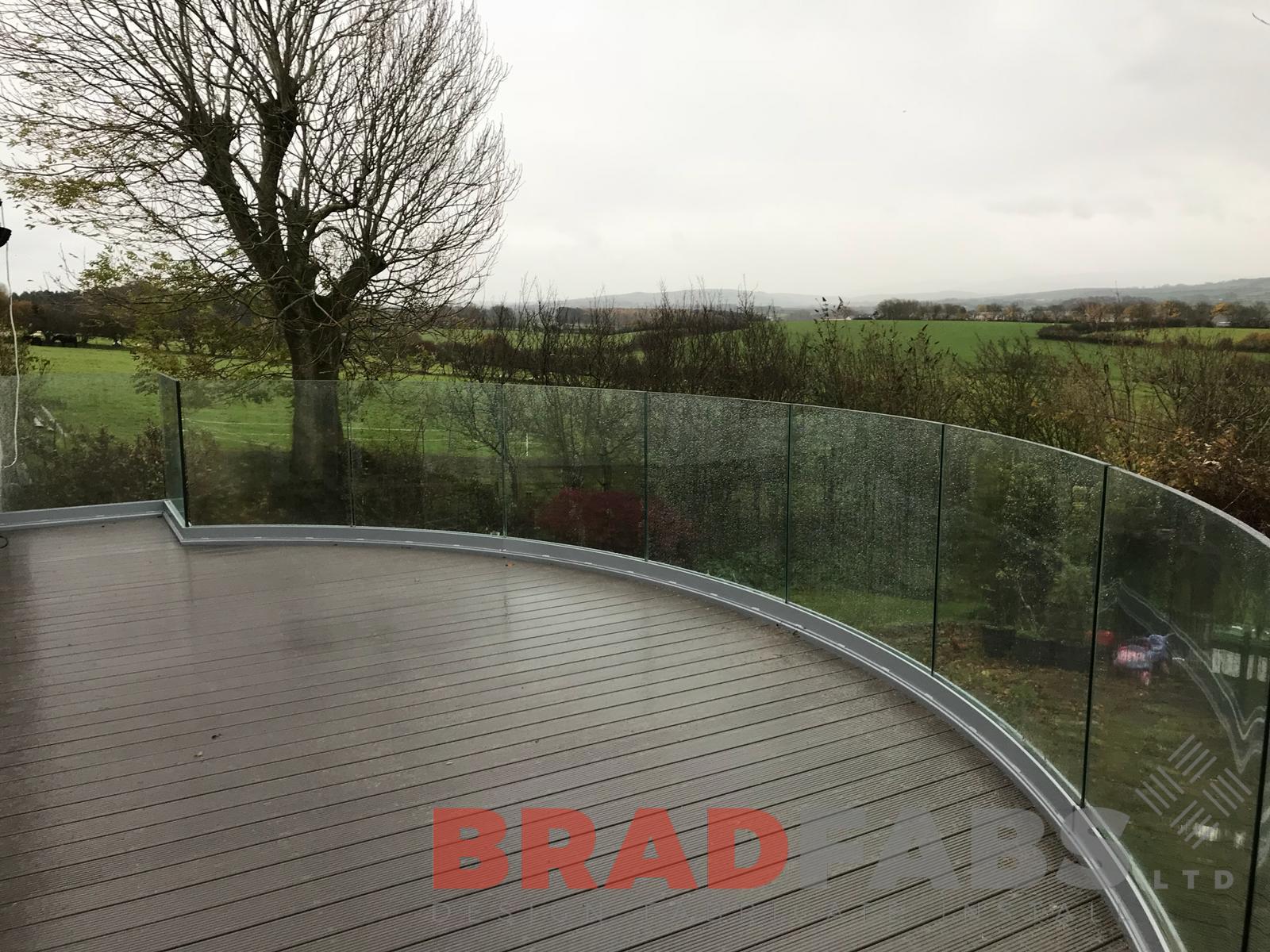 Curved helix balcony with curved infinity glass balustrade by Bradfabs 
