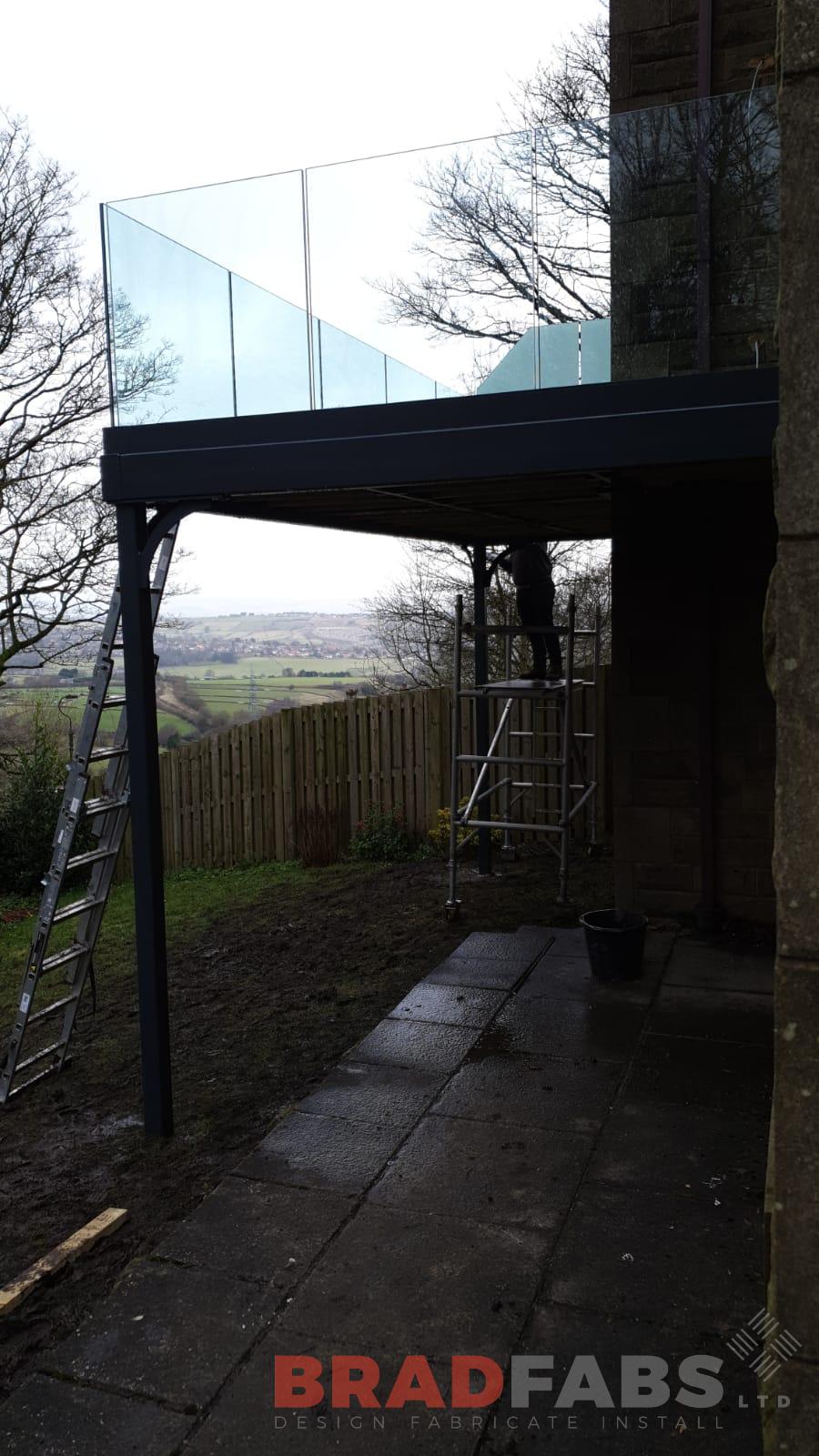 mild steel channel system balustrade with infinity glass balustrade with privacy screen to one side by Bradfabs Ltd 