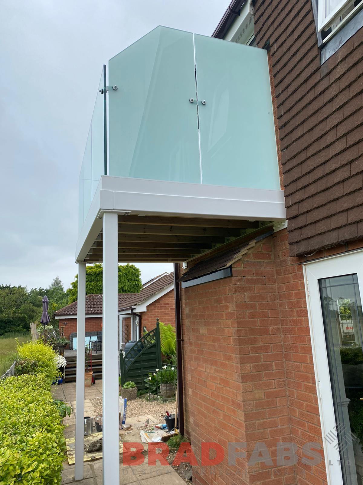 channel system infinity glass balustrade with privacy screen to one side, bespoke, designed, supplied and installed by bradfabs 