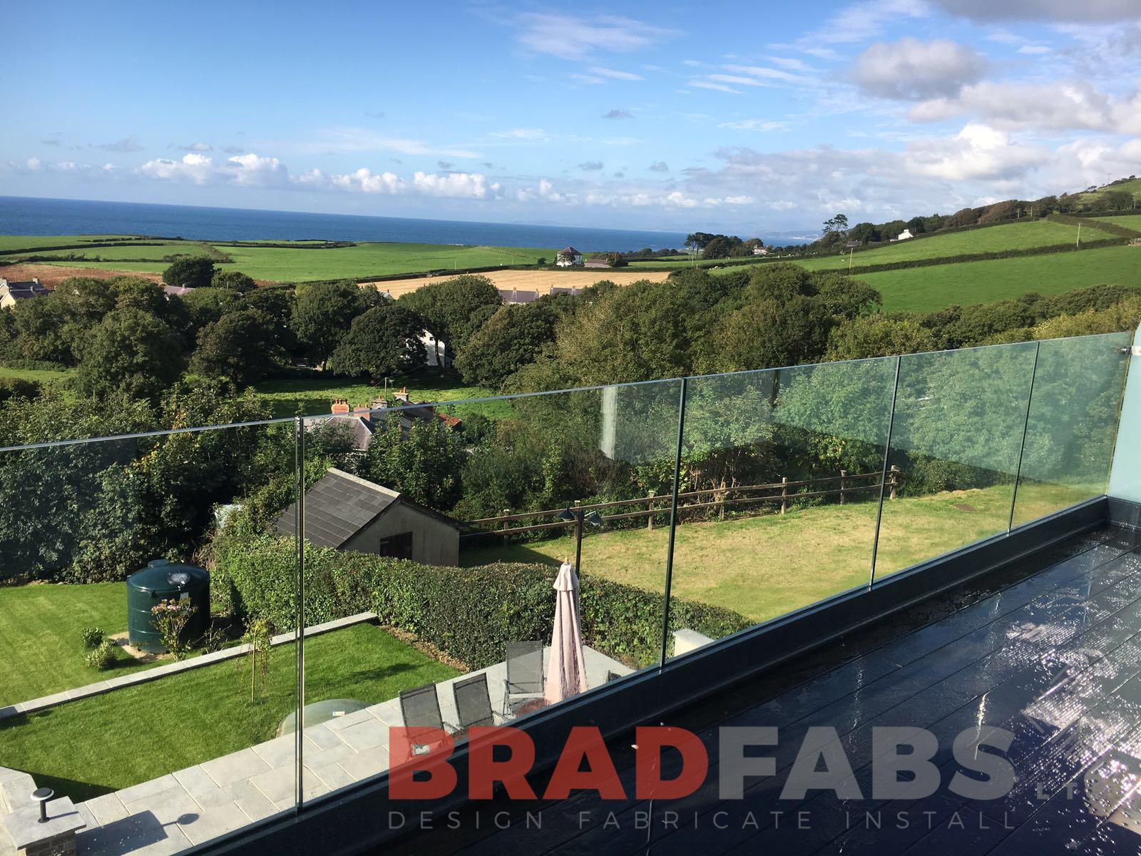 Our customer can now enjoy the view of their beautiful garden with infinity glass balustrade in a channel system balcony by Bradfabs 