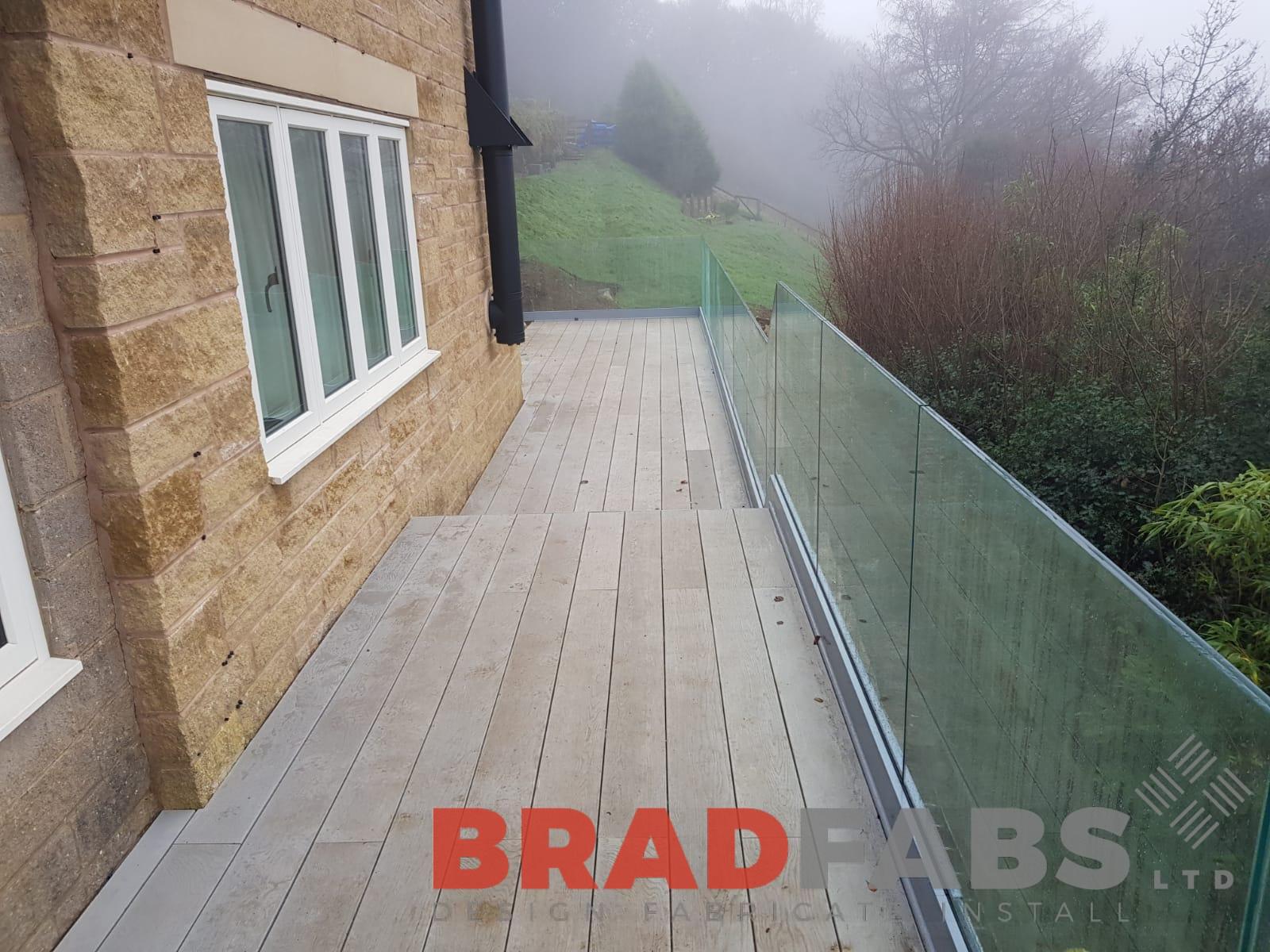 Channel system infinity glass balustrade on a large balcony by Bradfabs