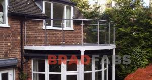 Curved balcony over bay window.