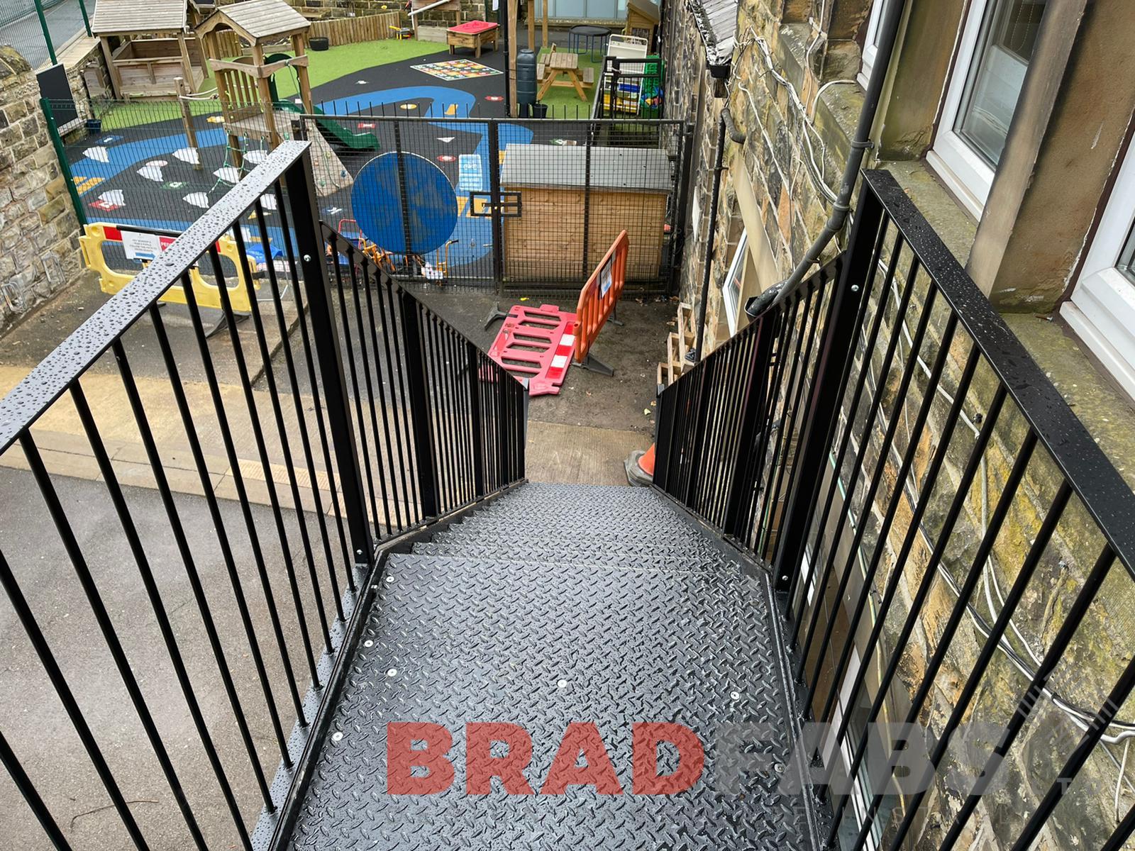 External School Fire Escape Staircase in mild steel, galvanised and powder coated with vertical bar balustrade and durbar treads manufactured and installed by School Experts Bradfabs