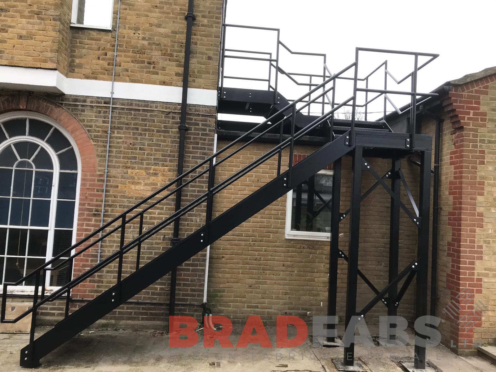 External straight staircase in mild steel galvanised and powder coated black with mid and top rail balustrade and durbar treads 