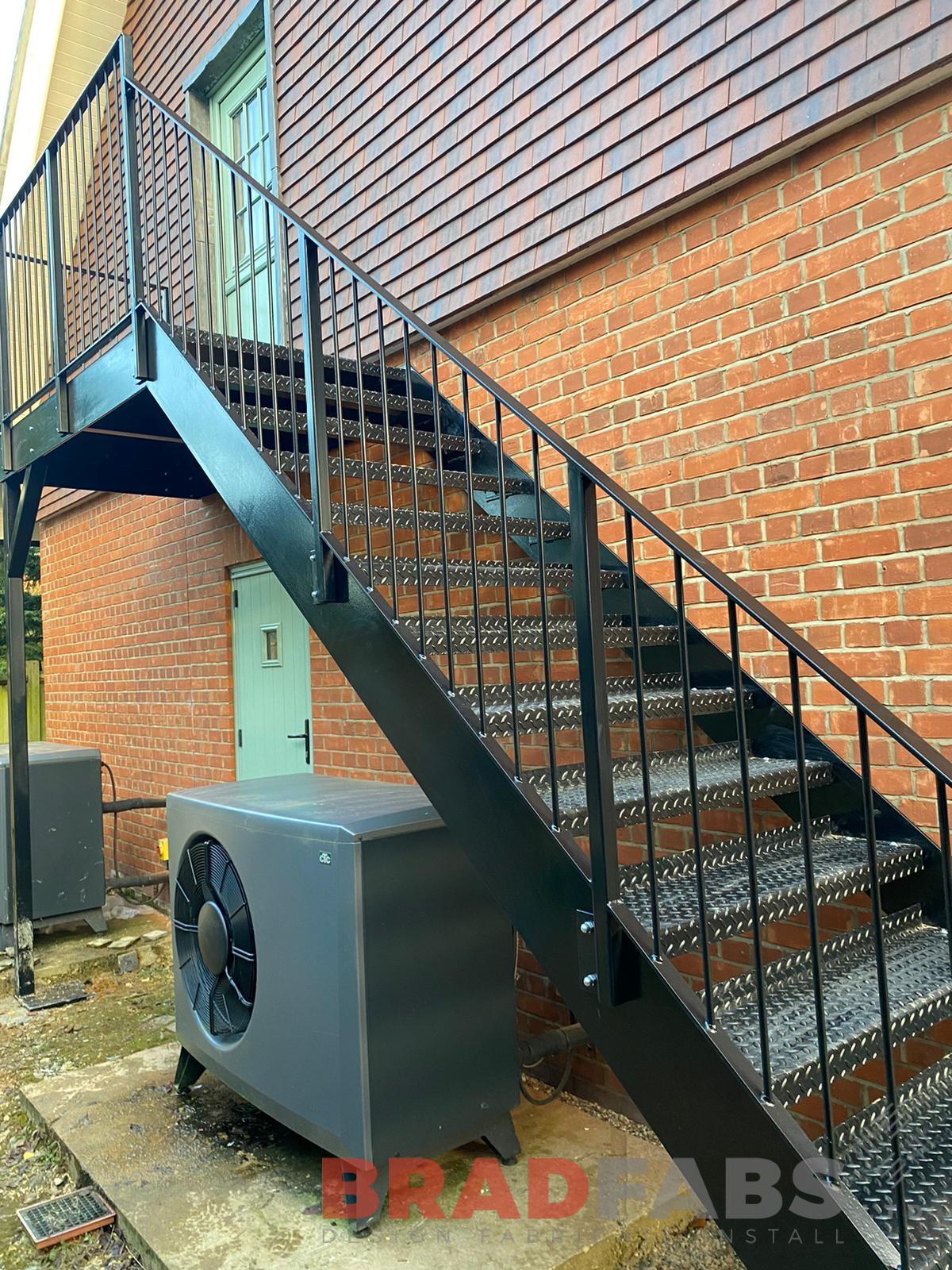 External steel staircase, galvanised and powder coated black, with vertical bar balustrade and tubular top rail and complete with durbar treads by bradfabs 