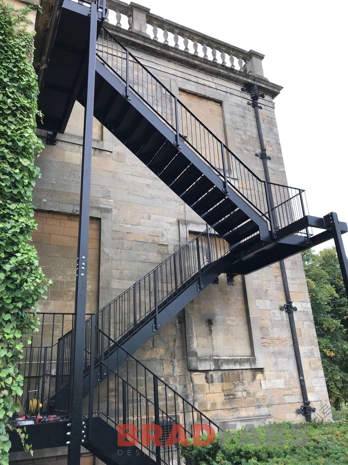 Straight fire escape mild steel powder coated black and galvanised with vertical bar balustrde and durbar treads