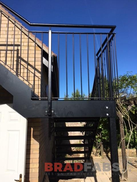 Mild steel, galvanised and powder coated black fire escape with vertical bar balustrade in black and complete with durbar treads 