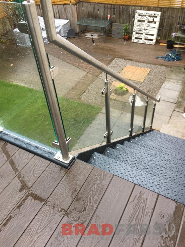 fire escape for a domestic property, manufactured in mild steel, galvanised and powder coated with stainless steel and glass balustrade, complete with durbar treads and composite decking on landings by Bradfabs 