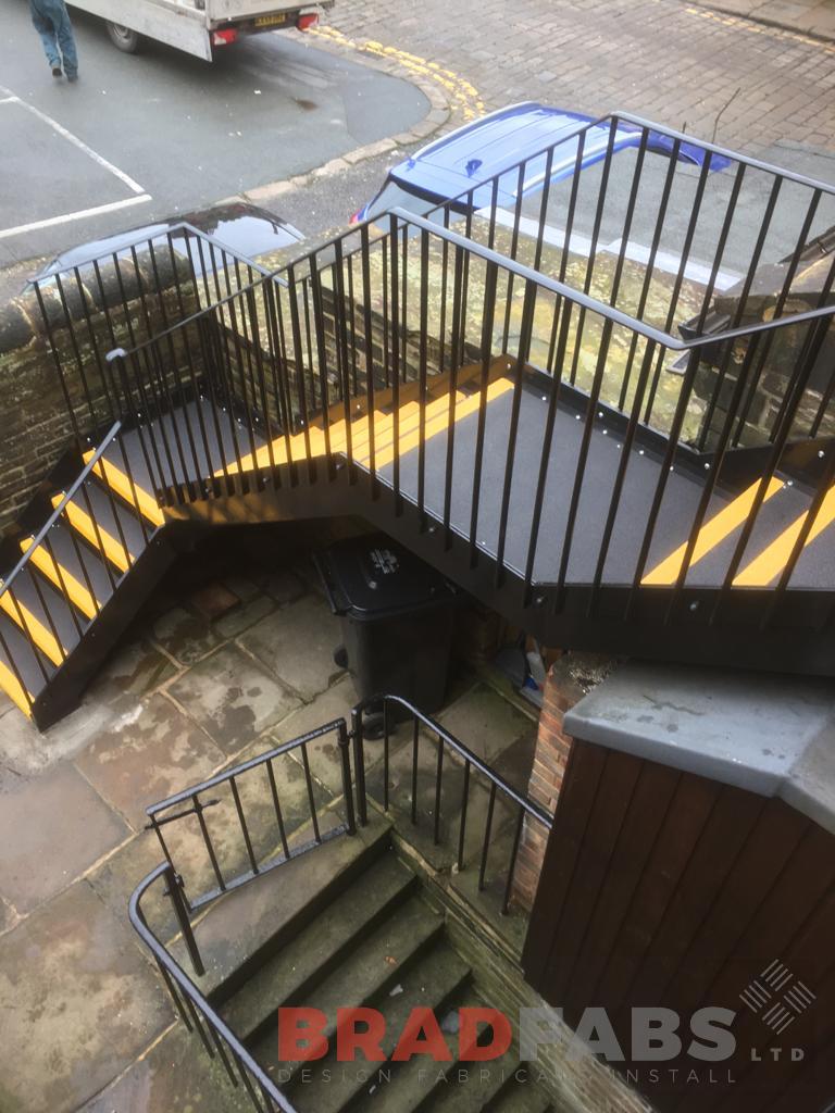 mild steel, galvanised and powder coated straight external staircase, with vertical bar balustrade on the stairs and landing, with durbar treads and yellow nosing by Bradfabs Ltd