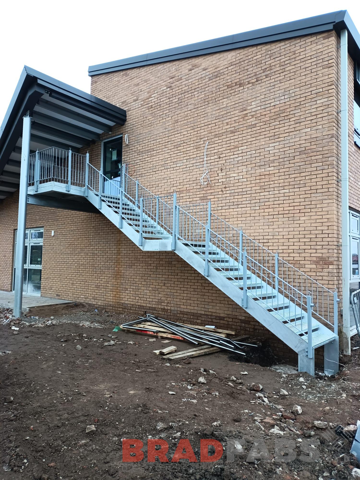 Large external staircase manufactured in mild steel and galvanised, with top landing, complete with durbar treads by bradfabs 