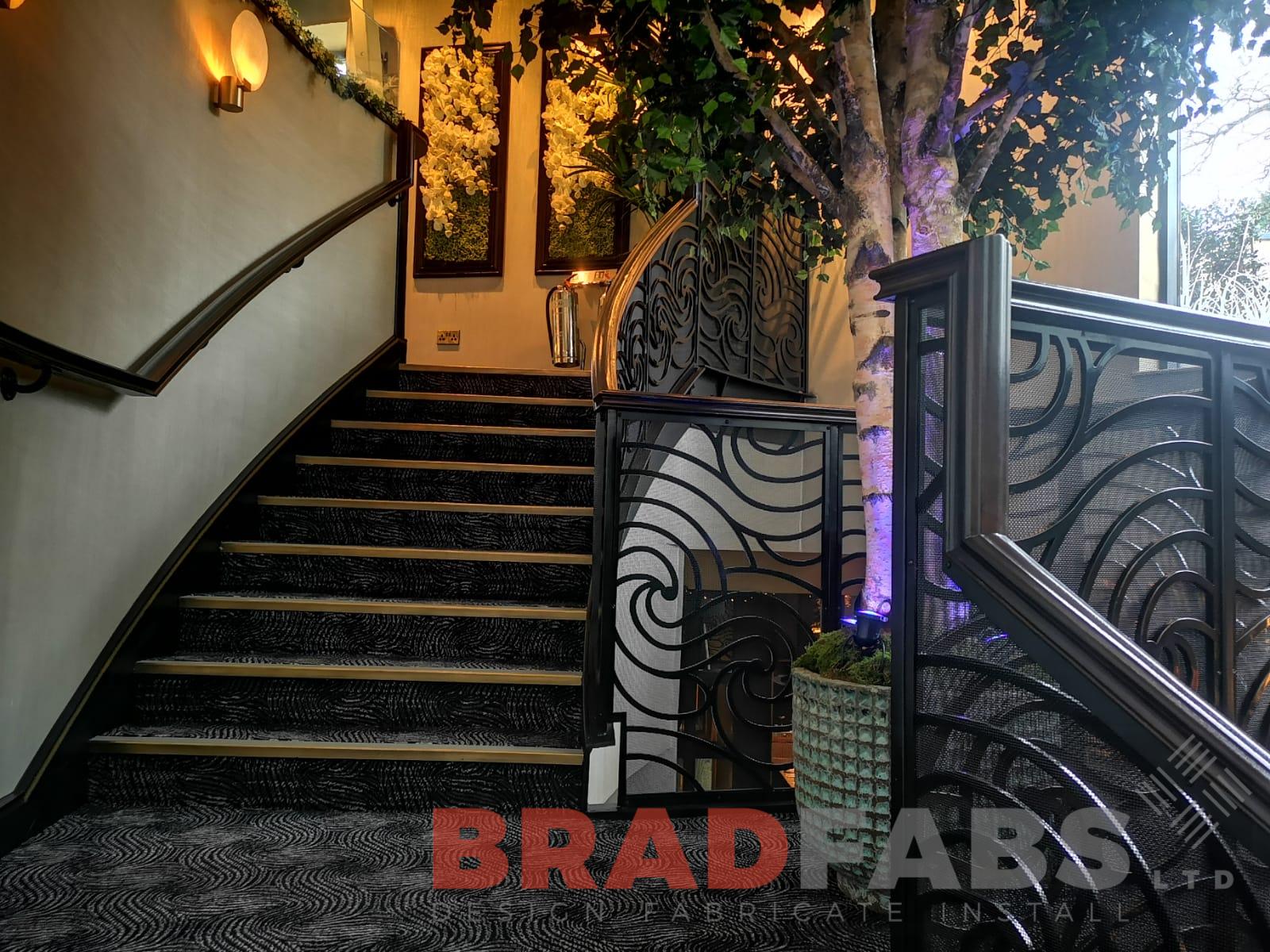Curved helical staircase with ornate balustrade by Bradfabs UK