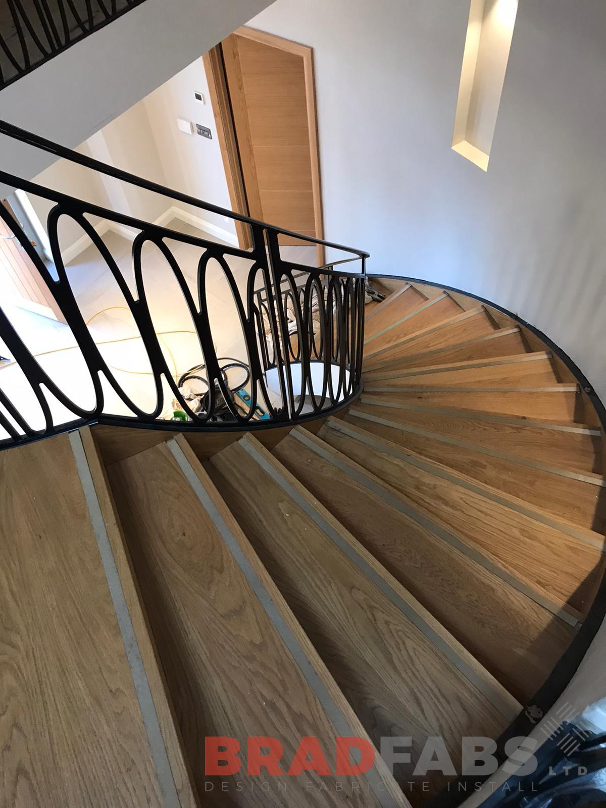 Bradfabs helical internal staircase for a domestic property with oak treads and feature stainless steel insert, with veneer stringer by Bradfabs 