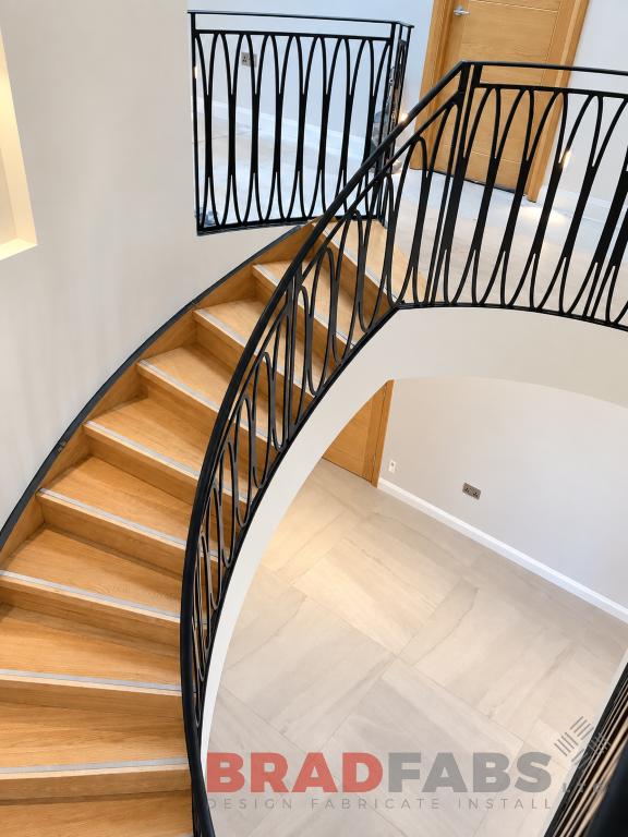  Bespoke helical staircase, oak treads with stainless steel insert and veneer stringer, laser cut feature balustrade by Bradfabs Ltd in Manchester