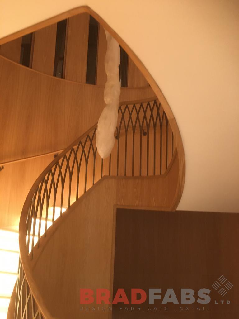 Individually designed grand helical staircase by Bradfabs, with decorative balustrade for a commercial project 