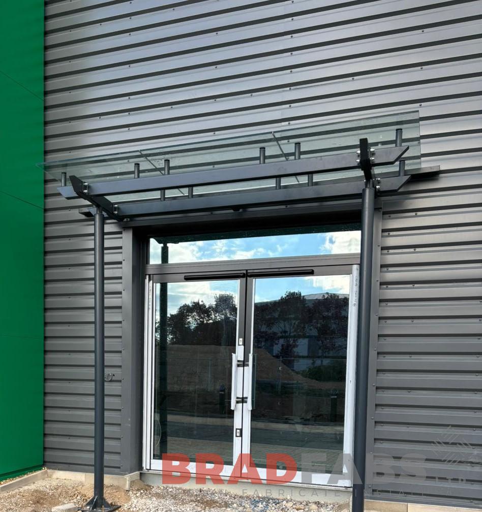 Powder Coated Door Canopies with Toughened Laminated Roof Panels | RAL 7016 Finish