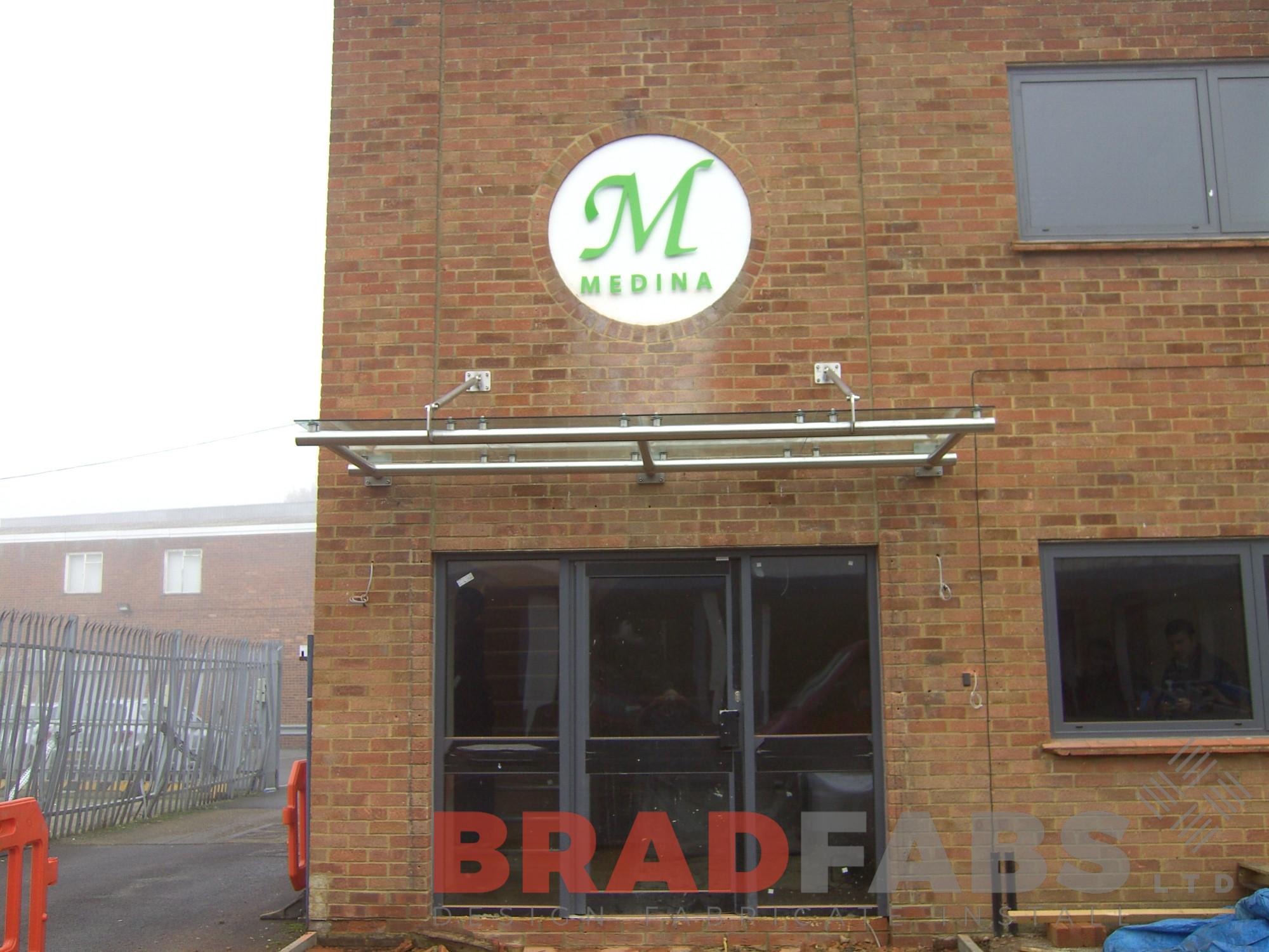 Canopy fabricated from glass and stainless steel installed in an office in Leeds West Yorkshire