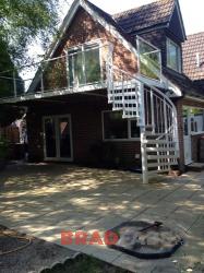 Bespoke balcony with spiral staircase, with glass panels on the balcony and railings on the staircase by Bradfabs 