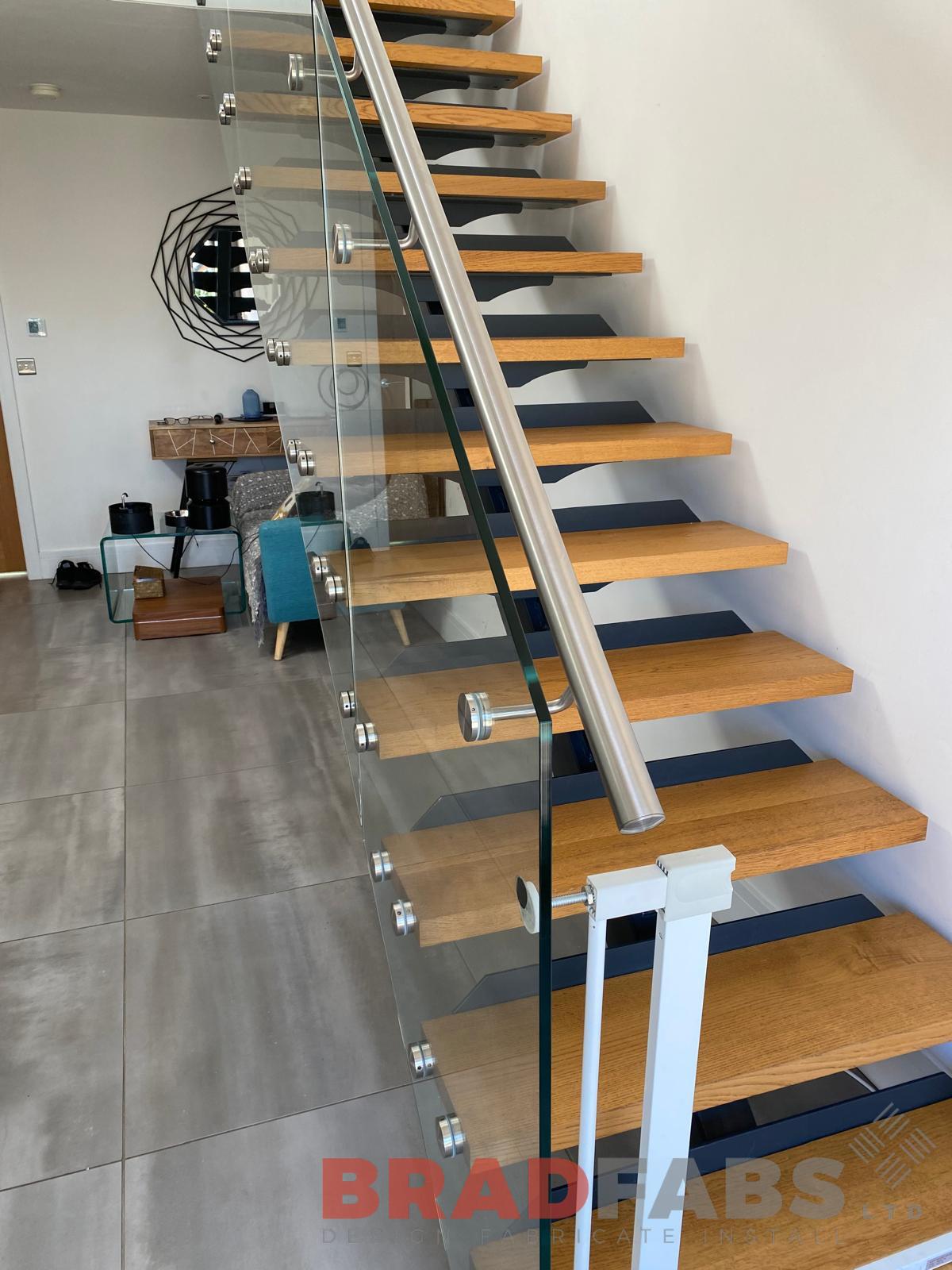 Floating straight stairs with bolt on glass