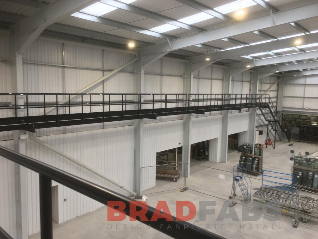 large steel internal walkway leading to a straight staircase by Bradfabs 