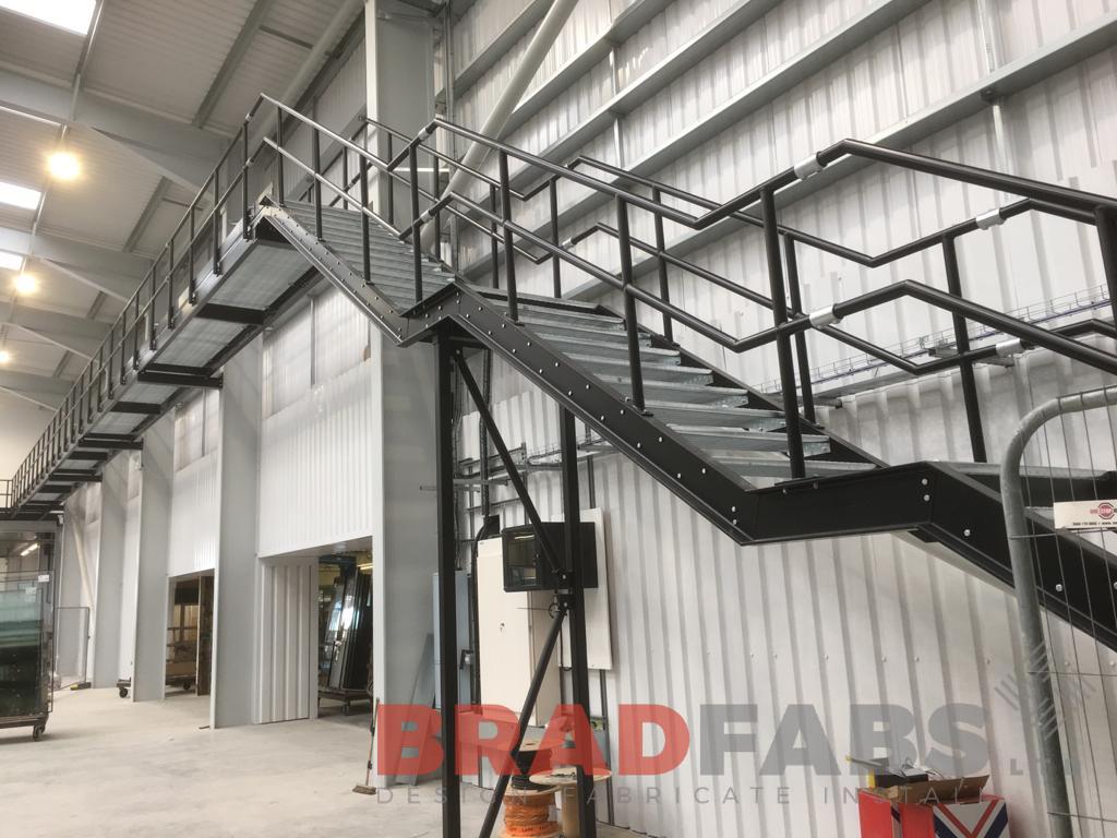 large steel internal walkway leading to a straight staircase by Bradfabs 