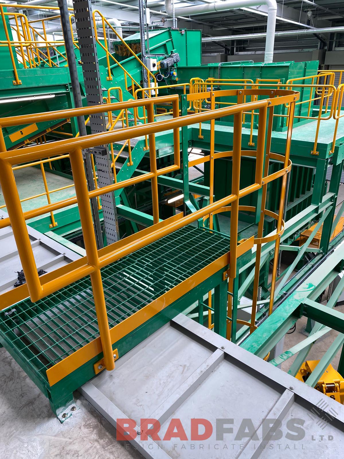 bespoke mild steel walkway, with the top and mid rail balustrade powder coated yellow, and the flooring powder coated light green by Bradfabs