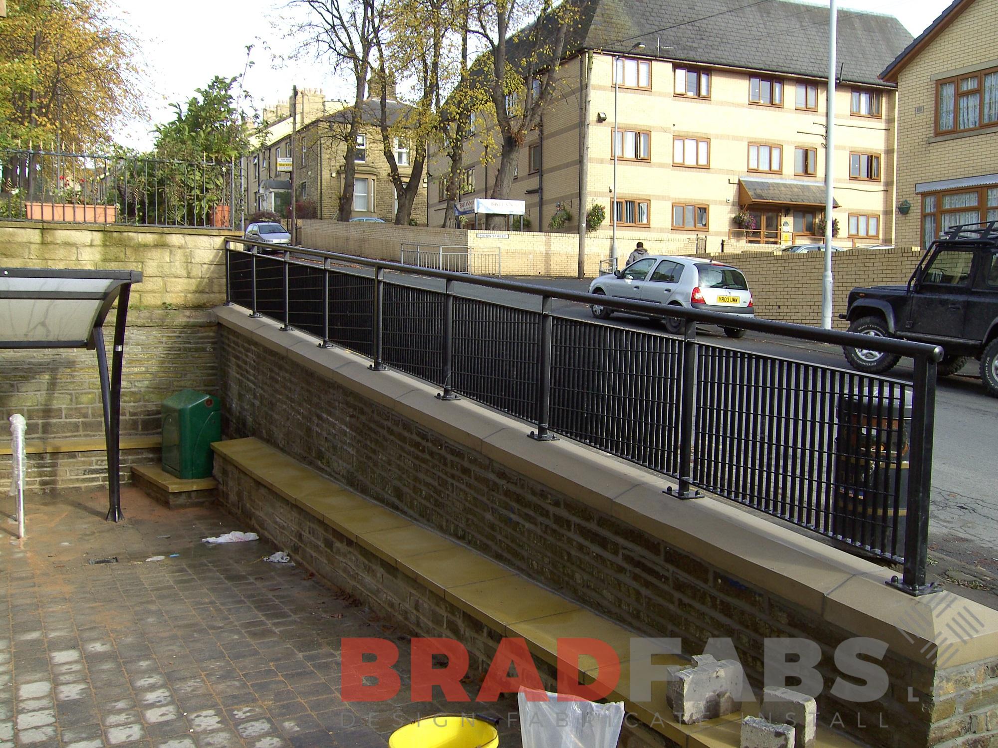 Wall mounted black steel railings installed by Bradfabs